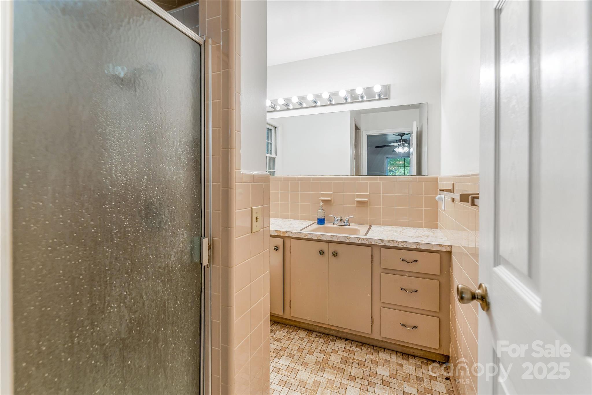 679 Solomon Jones Road Cedar Mountain, NC 28718 - Photo 25 of 47 a spacious bathroom with a double vanity sink and a mirror