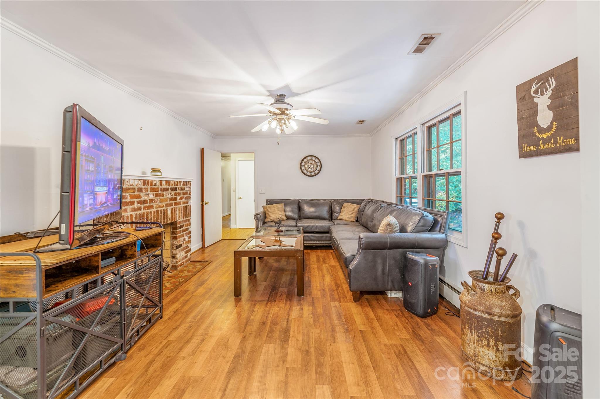 679 Solomon Jones Road Cedar Mountain, NC 28718 - Photo 30 of 47 a living room with furniture a fireplace and a flat screen tv