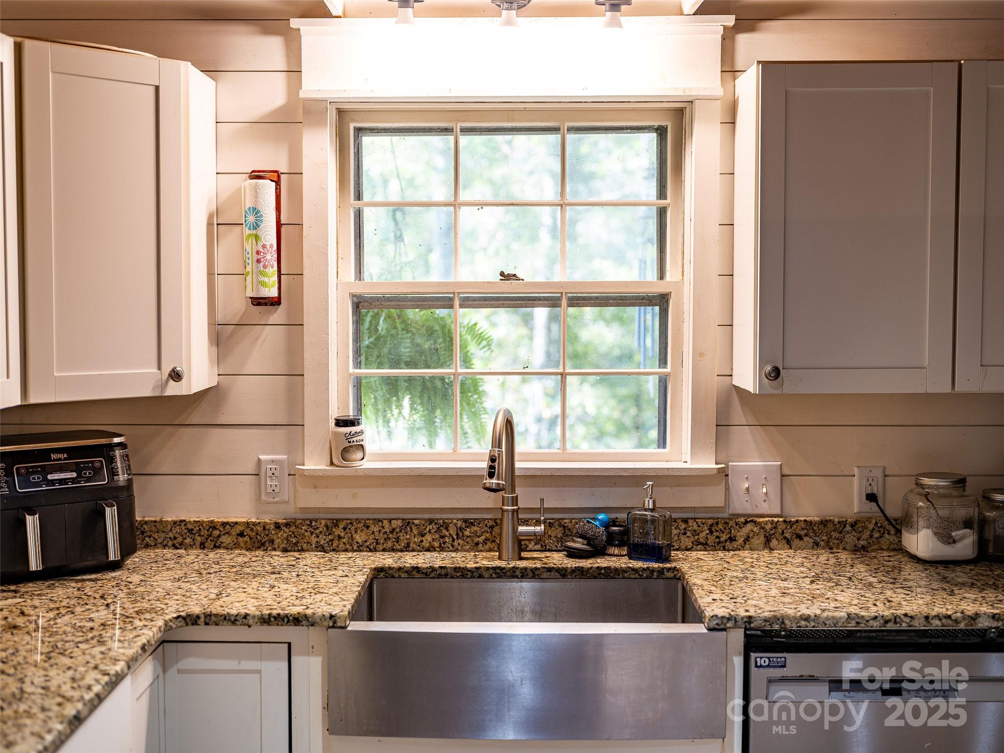 679 Solomon Jones Road Cedar Mountain, NC 28718 - Photo 36 of 47 a kitchen with granite countertop a sink and a counter top space