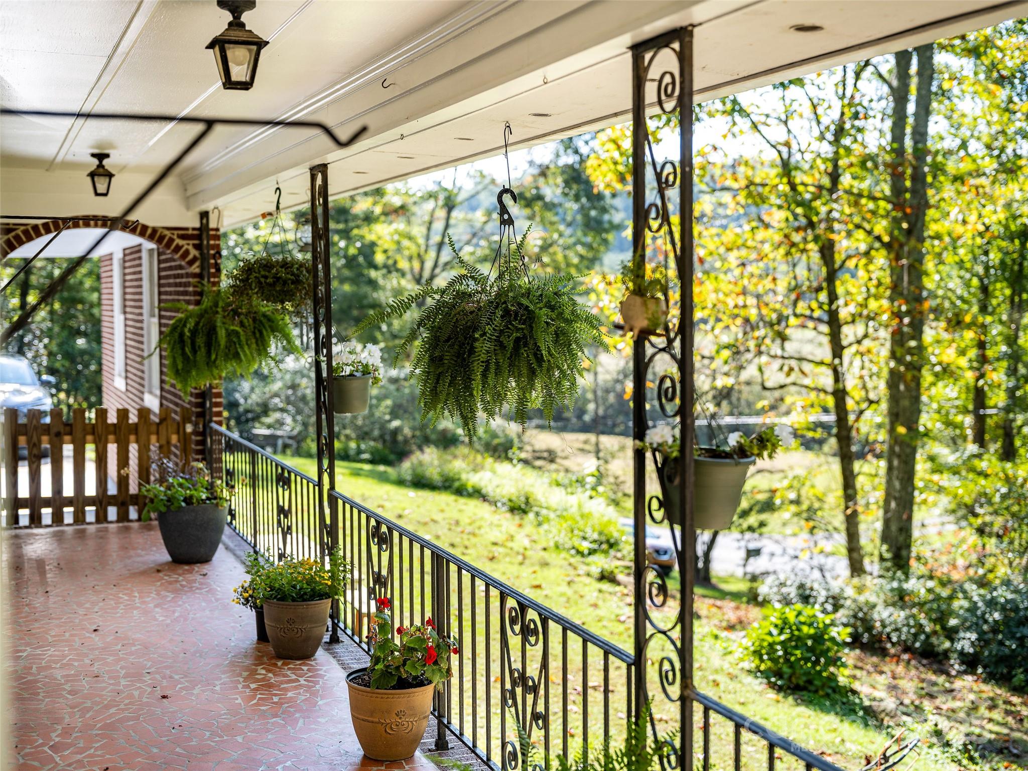 679 Solomon Jones Road Cedar Mountain, NC 28718 - Photo 38 of 47 a view of a porch with chairs and potted plants