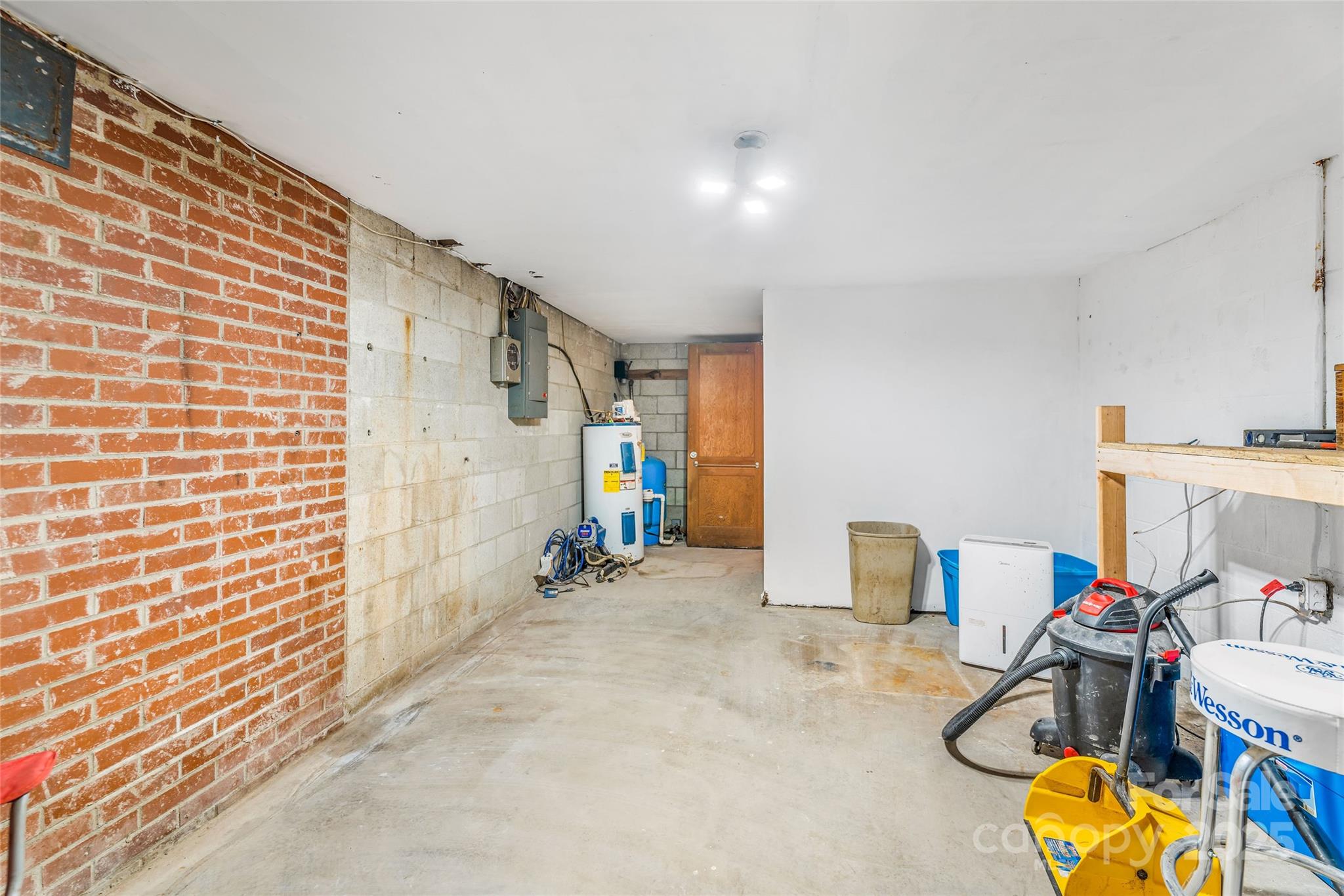 679 Solomon Jones Road Cedar Mountain, NC 28718 - Photo 39 of 47 a view of a workspace with furniture and a flat screen tv