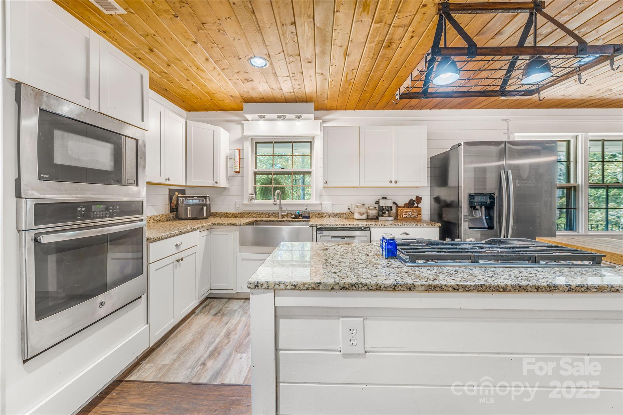 679 Solomon Jones Road Cedar Mountain, NC 28718 - Photo 8 of 47 a kitchen with stainless steel appliances granite countertop a stove a sink and a microwave