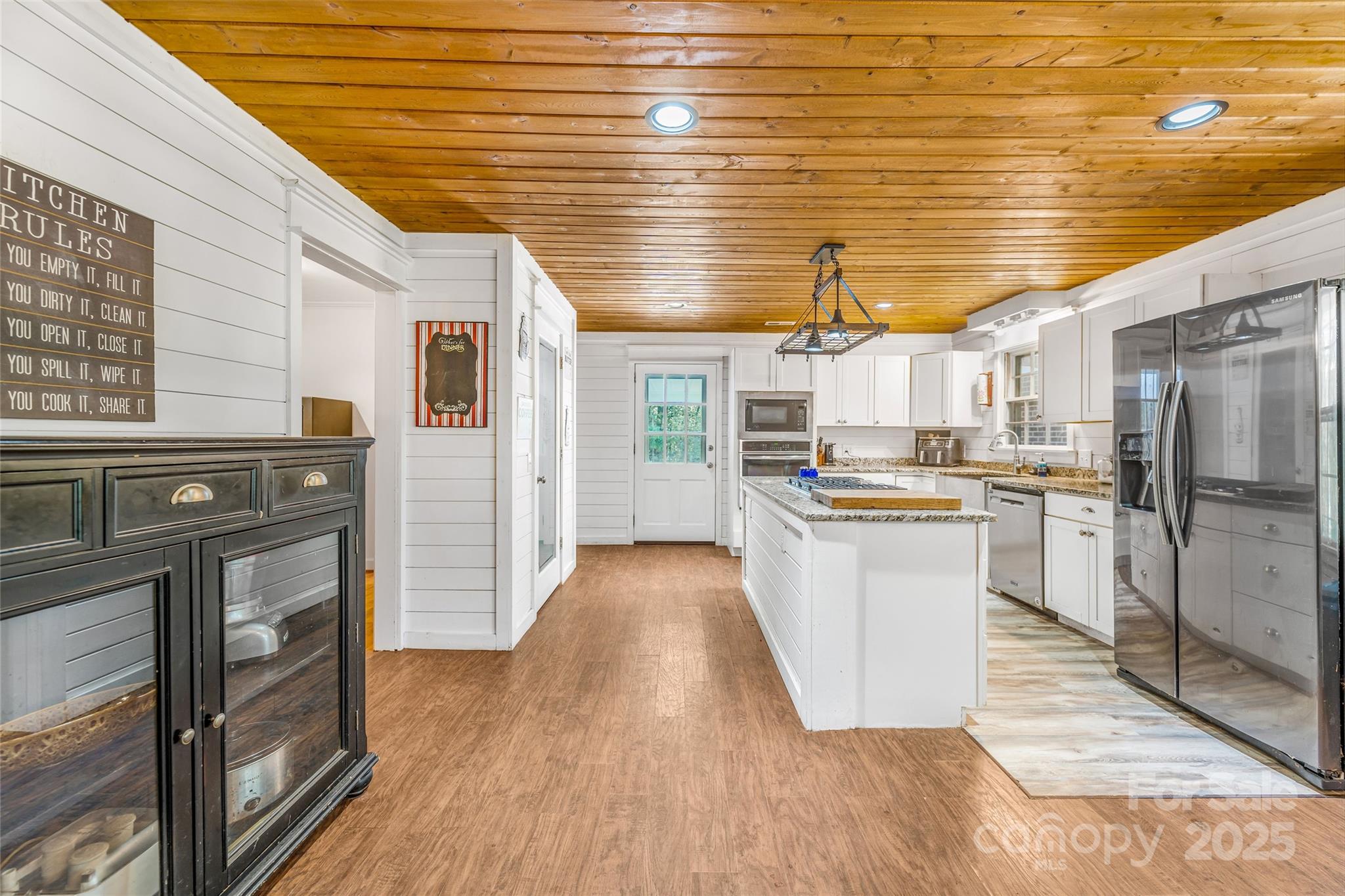 679 Solomon Jones Road Cedar Mountain, NC 28718 - Photo 9 of 47 a kitchen with cabinets and wooden floor