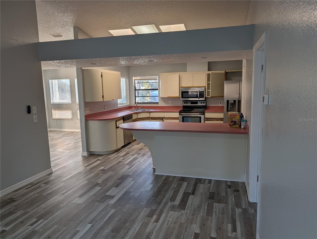 5327 Baldock Avenue Spring Hill, FL 34608 - Photo 11 of 14 a dining hall with wooden floor and a cabinet
