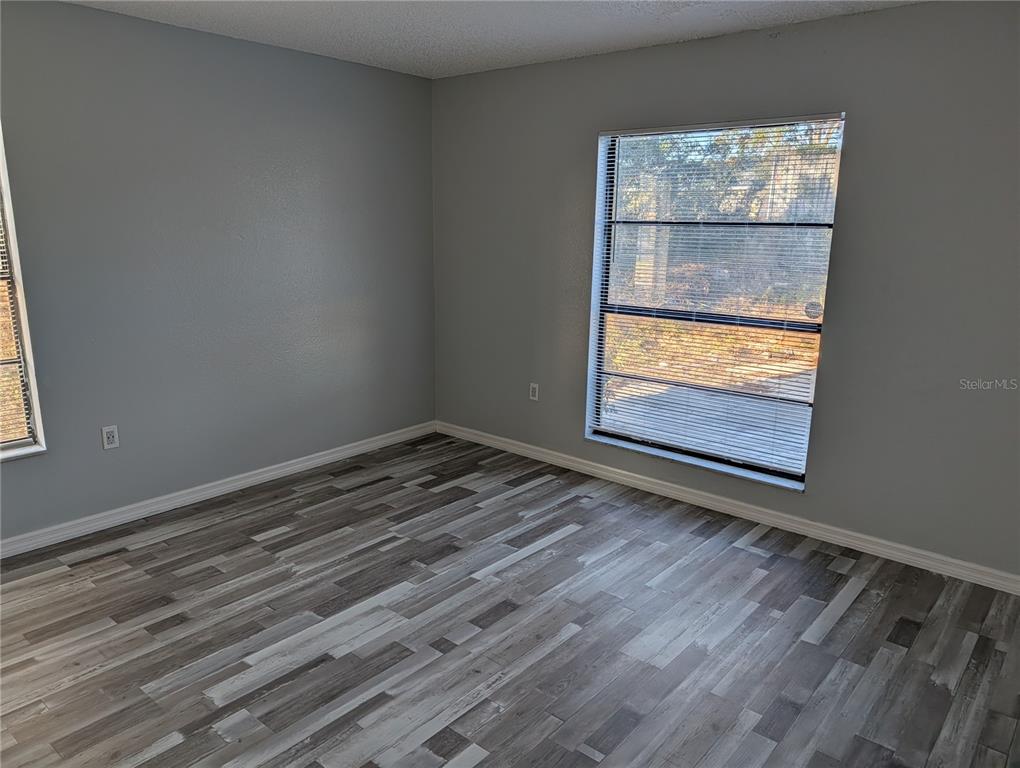 5327 Baldock Avenue Spring Hill, FL 34608 - Photo 12 of 14 a view of empty room with wooden floor and fan