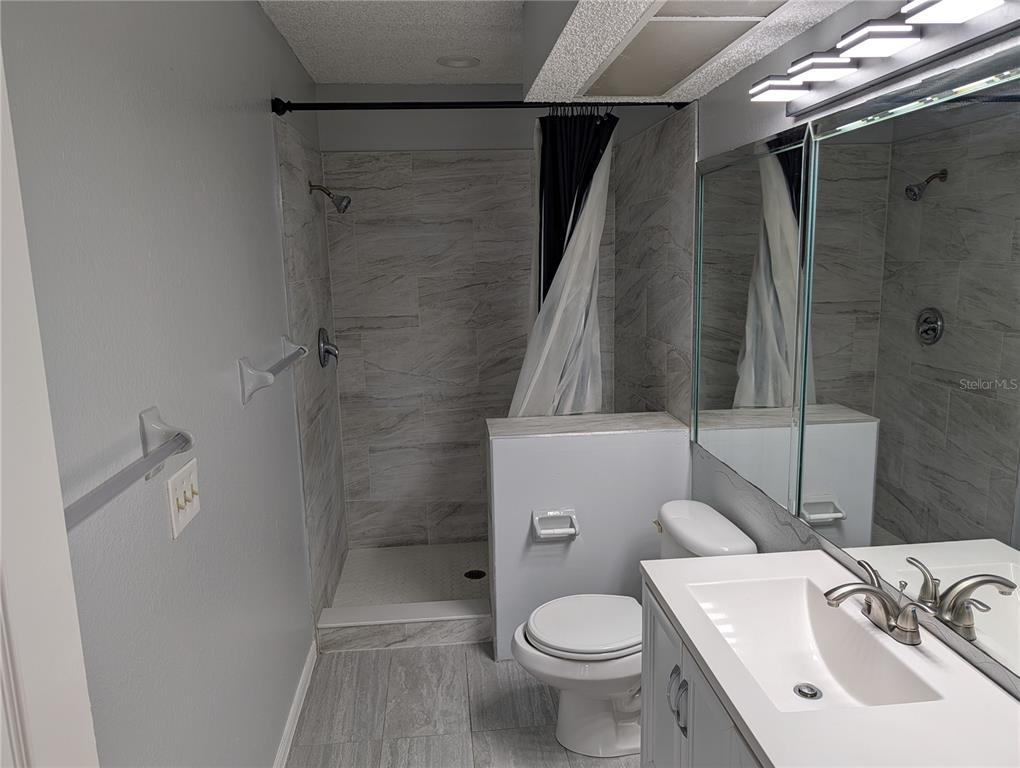 5327 Baldock Avenue Spring Hill, FL 34608 - Photo 13 of 14 a bathroom with a sink toilet and shower