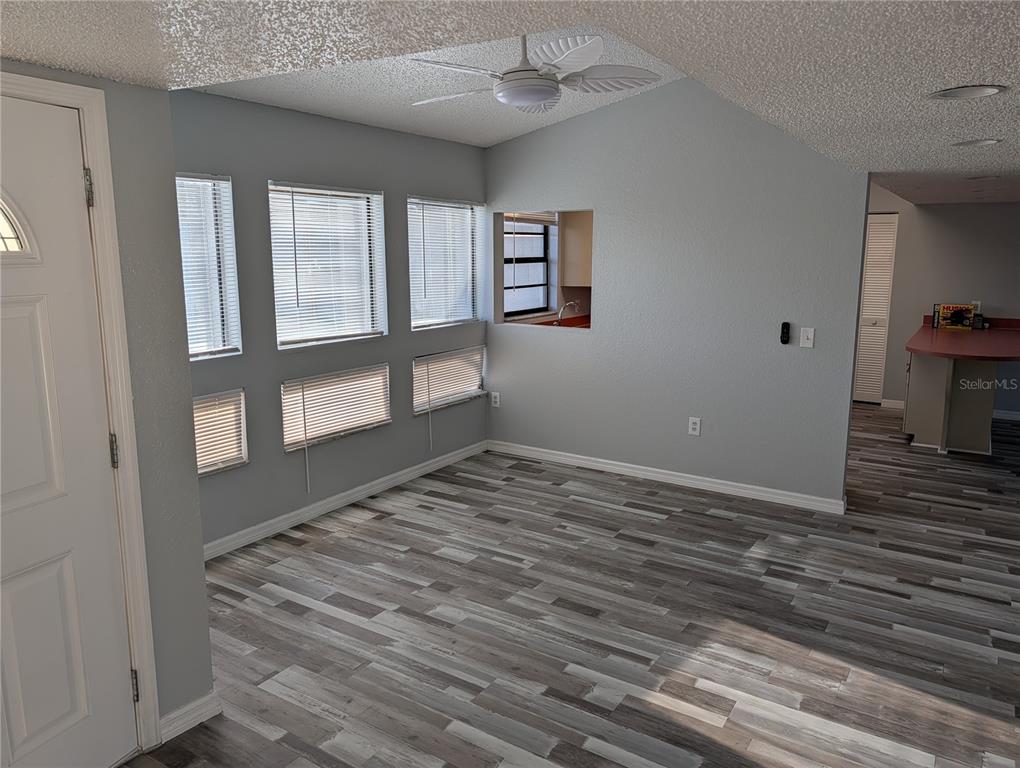 5327 Baldock Avenue Spring Hill, FL 34608 - Photo 4 of 14 a view of an empty room with window and wooden floor