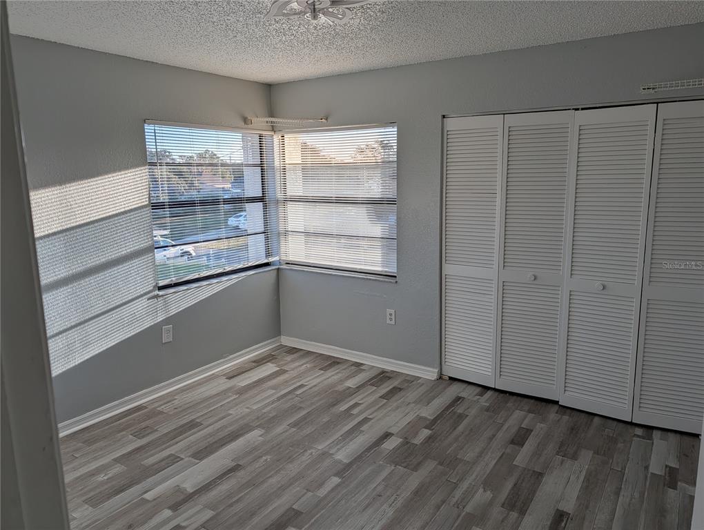 5327 Baldock Avenue Spring Hill, FL 34608 - Photo 5 of 14 a view of an empty room with wooden floor and a window