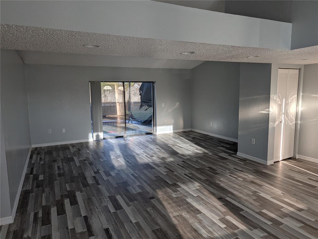 5327 Baldock Avenue Spring Hill, FL 34608 - Photo 8 of 14 a view of empty room with wooden floor