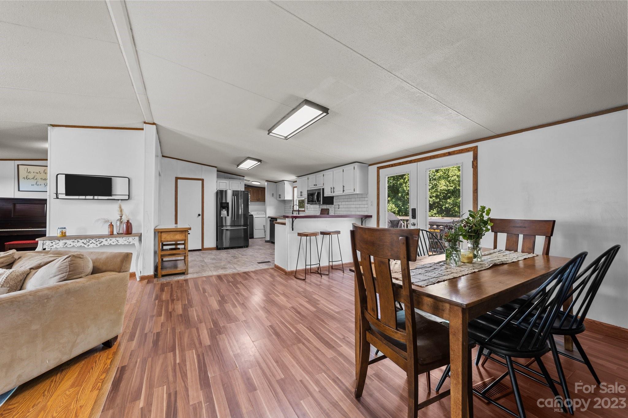 1246 Lambert Road Hiddenite, NC 28636 - Photo 14 of 22 a view of a dining room with furniture and wooden floor
