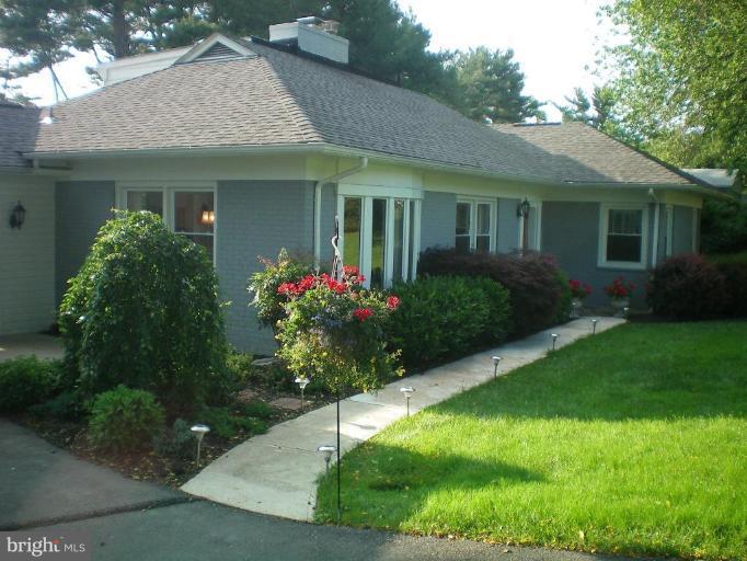 4030 Crescent Road Ellicott City, MD 21042 - Photo 1 of 29 a front view of a house with a garden