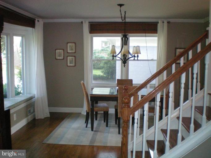 4030 Crescent Road Ellicott City, MD 21042 - Photo 13 of 29 a view of a hallway with wooden floor and stairs