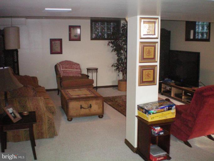 4030 Crescent Road Ellicott City, MD 21042 - Photo 17 of 29 a living room with furniture and a flat screen tv