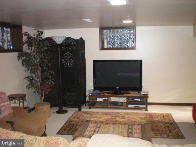 4030 Crescent Road Ellicott City, MD 21042 - Photo 18 of 29 a living room with furniture and a flat screen tv