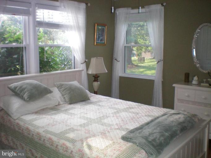 4030 Crescent Road Ellicott City, MD 21042 - Photo 20 of 29 a bedroom with a bed and a dresser next to a window