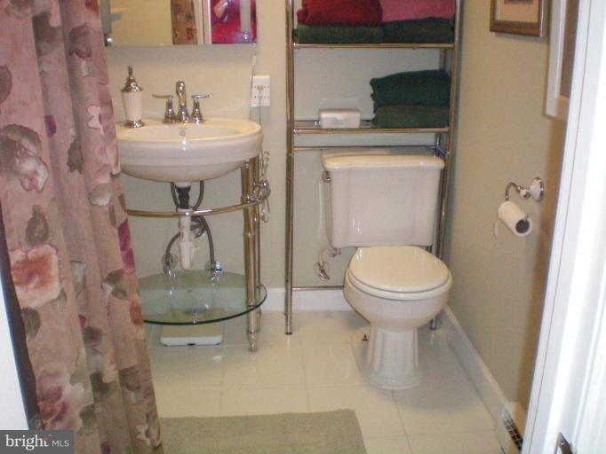 4030 Crescent Road Ellicott City, MD 21042 - Photo 24 of 29 a bathroom with a sink toilet and a mirror