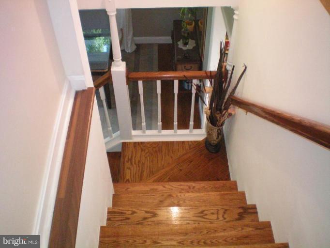 4030 Crescent Road Ellicott City, MD 21042 - Photo 25 of 29 a view of entryway with wooden floor and stairs