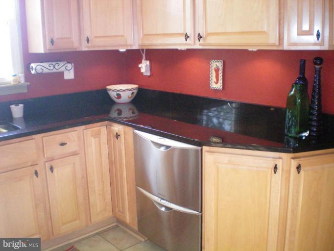 4030 Crescent Road Ellicott City, MD 21042 - Photo 4 of 29 a kitchen with granite countertop a refrigerator and stove