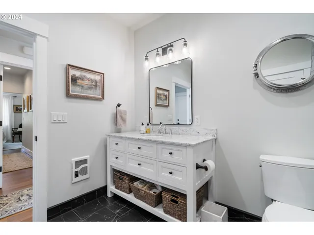 a bathroom with a toilet sink and mirror