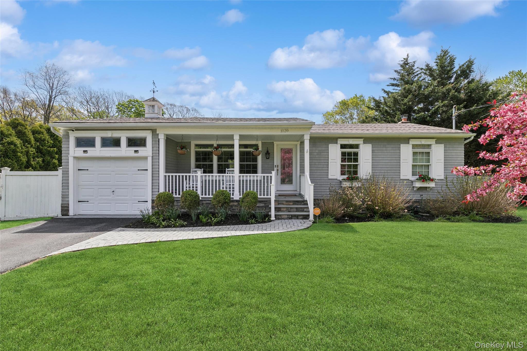 a front view of a house with a garden