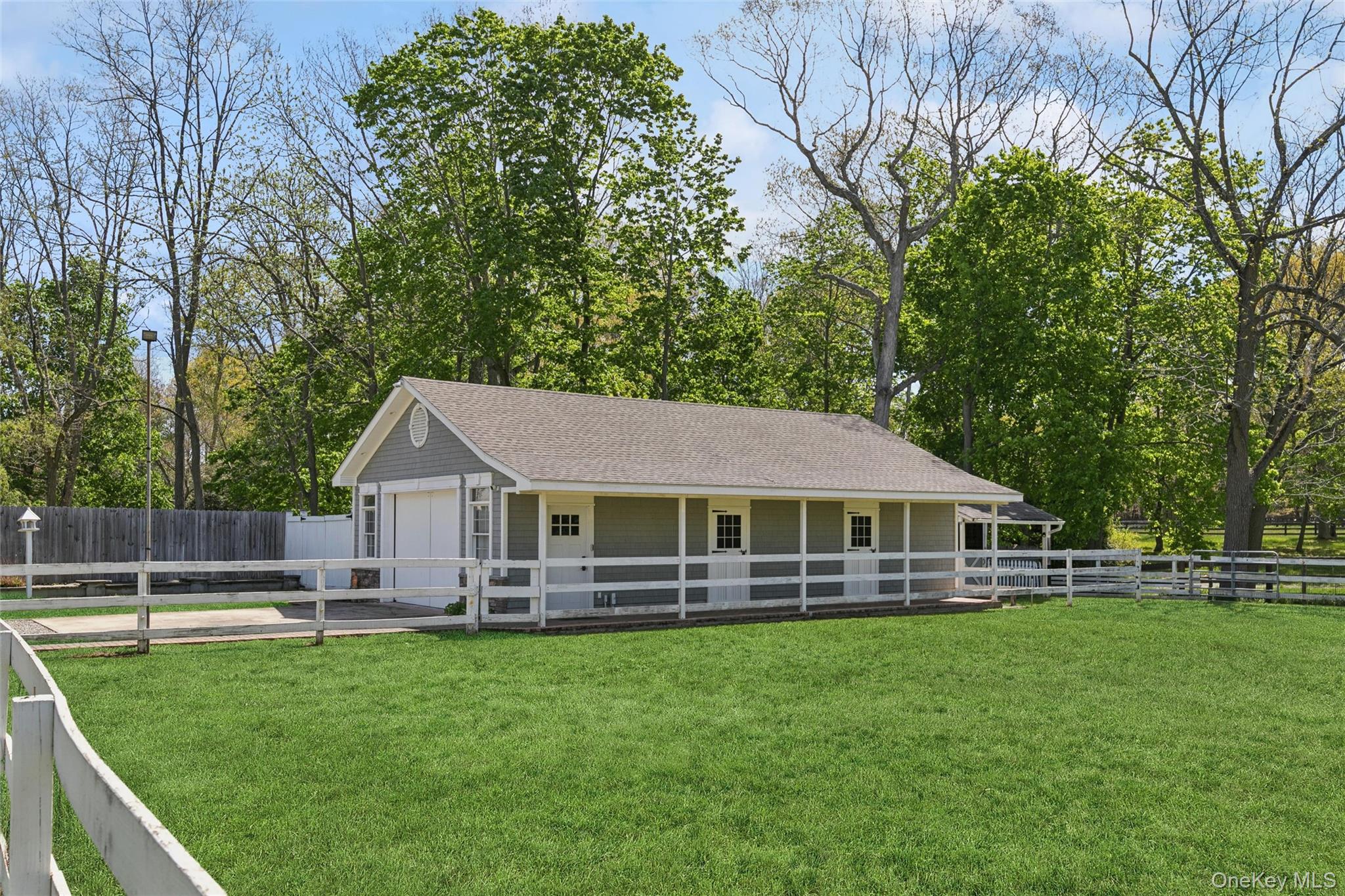 1039 Middle Road Riverhead, NY 11901 - Photo 11 of 34 a front view of a house with a yard table and chairs