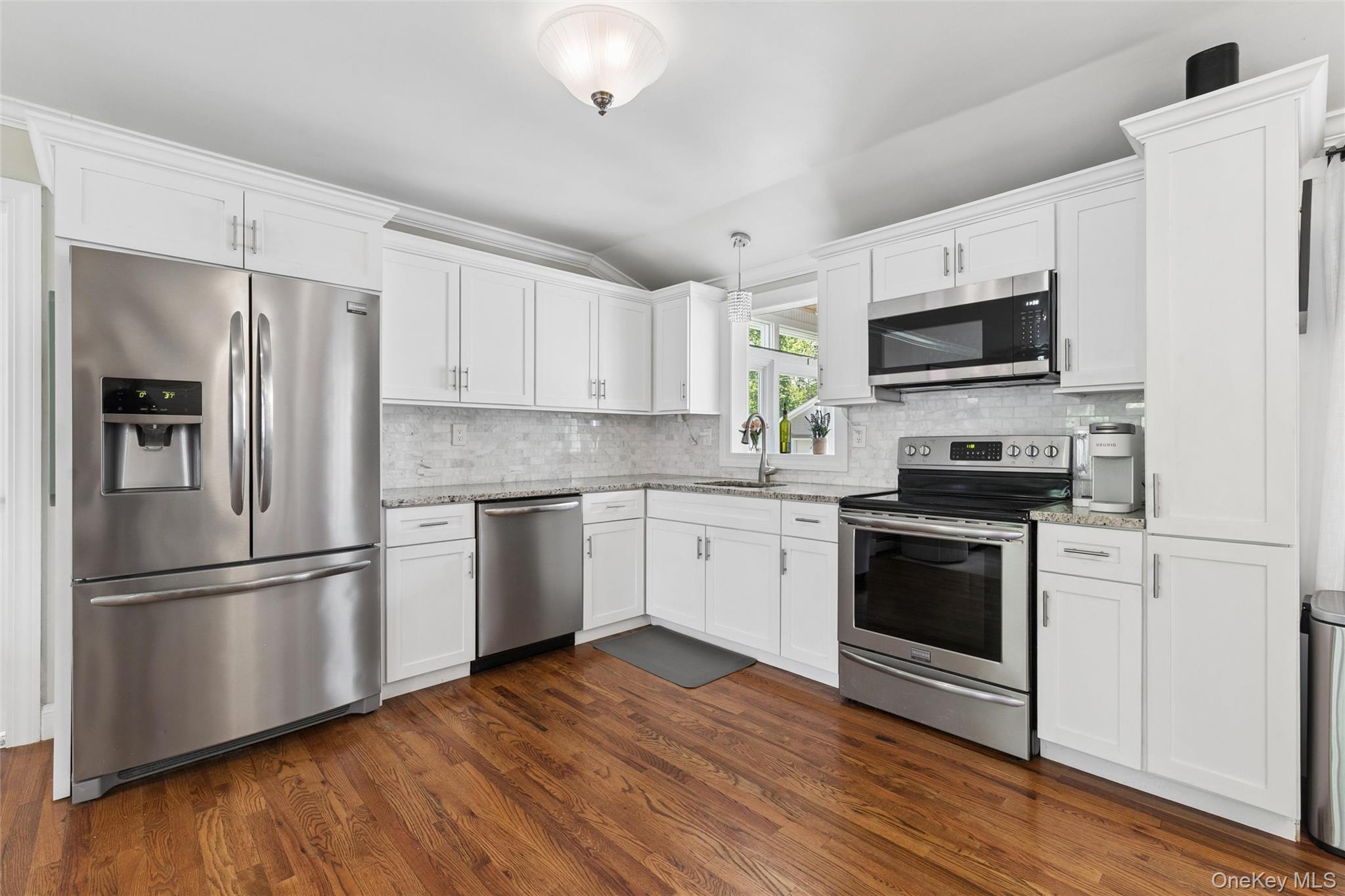 1039 Middle Road Riverhead, NY 11901 - Photo 17 of 34 a kitchen with a refrigerator stove and microwave