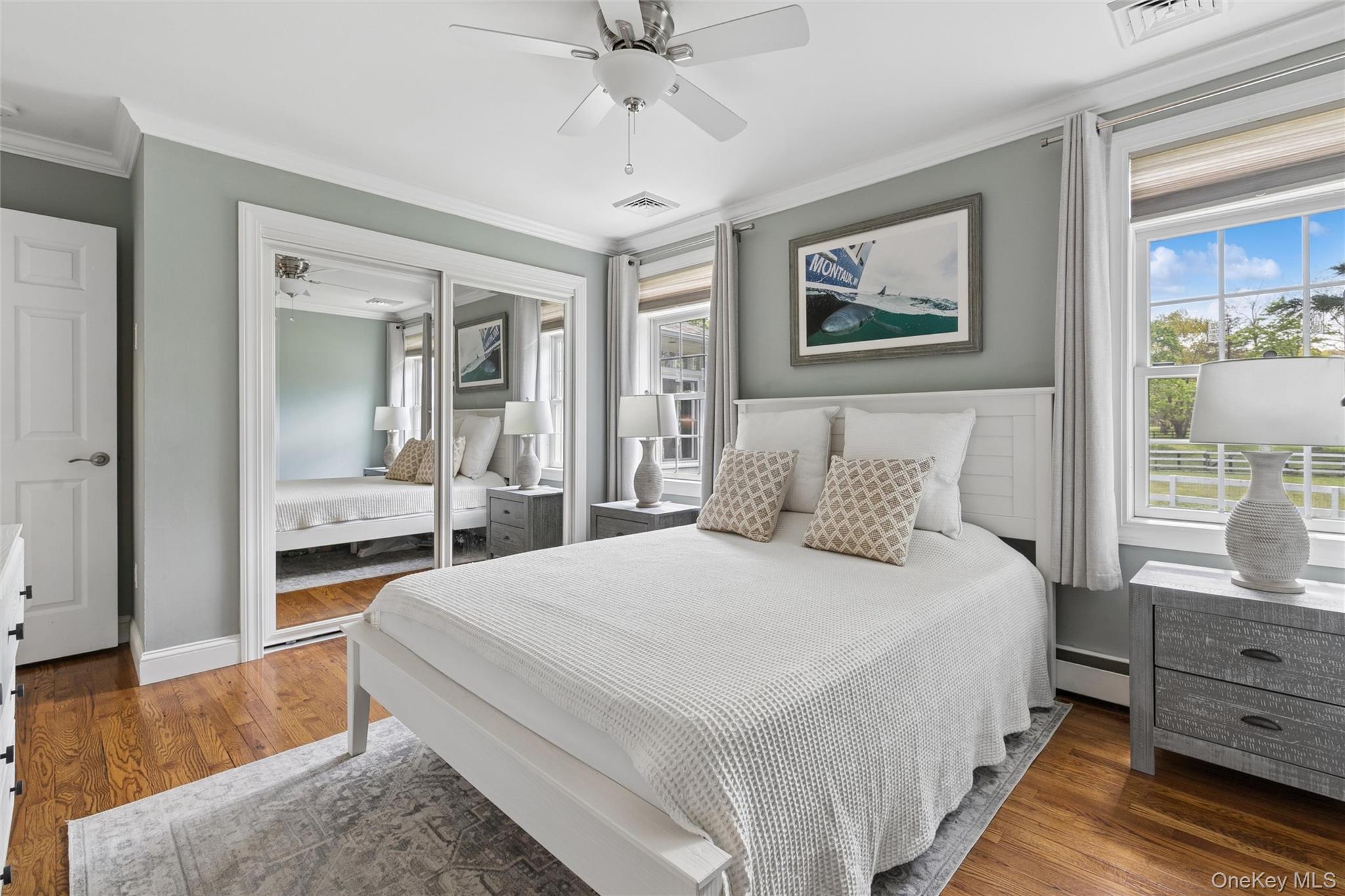1039 Middle Road Riverhead, NY 11901 - Photo 25 of 34 a bedroom with a bed and a chandelier