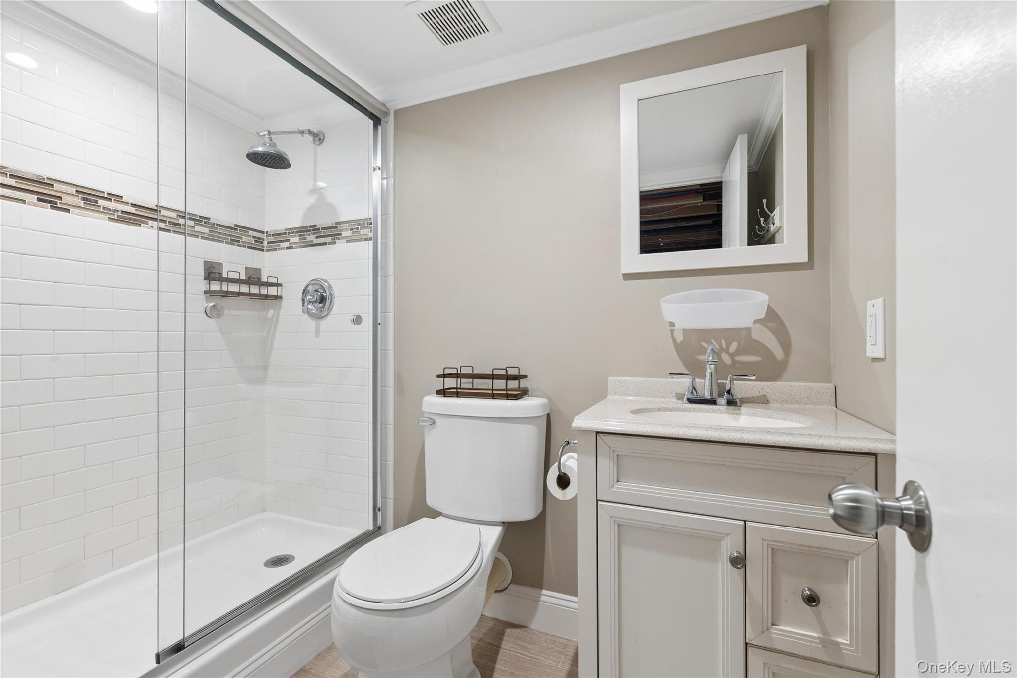 1039 Middle Road Riverhead, NY 11901 - Photo 31 of 34 a bathroom with a sink a toilet and shower