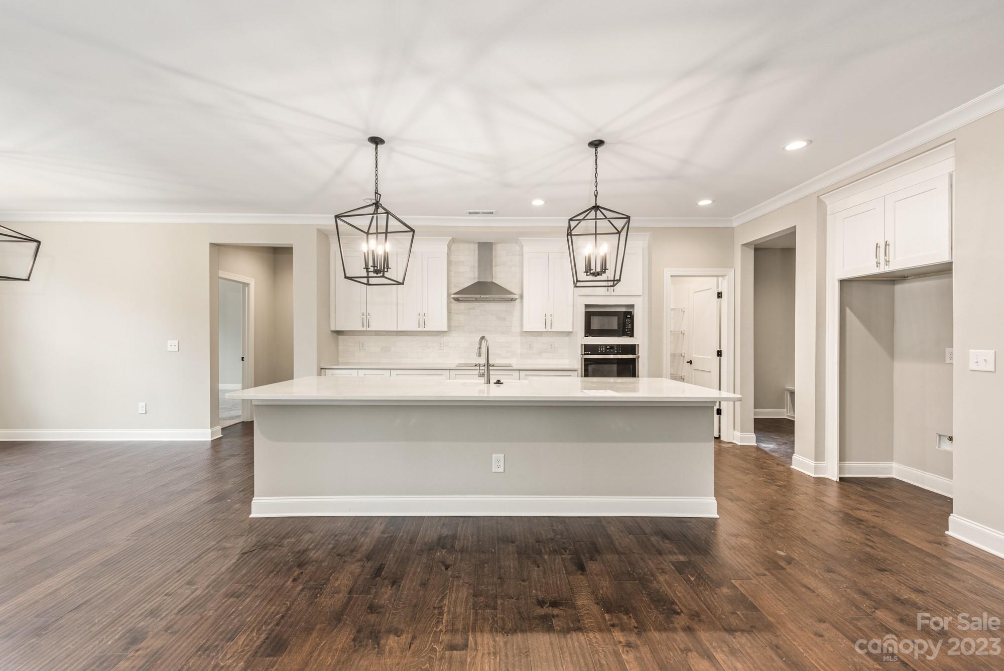 4024 Red Hl Way Denver, NC 28037 - Photo 18 of 22 a living room with kitchen island dining table and wooden floor