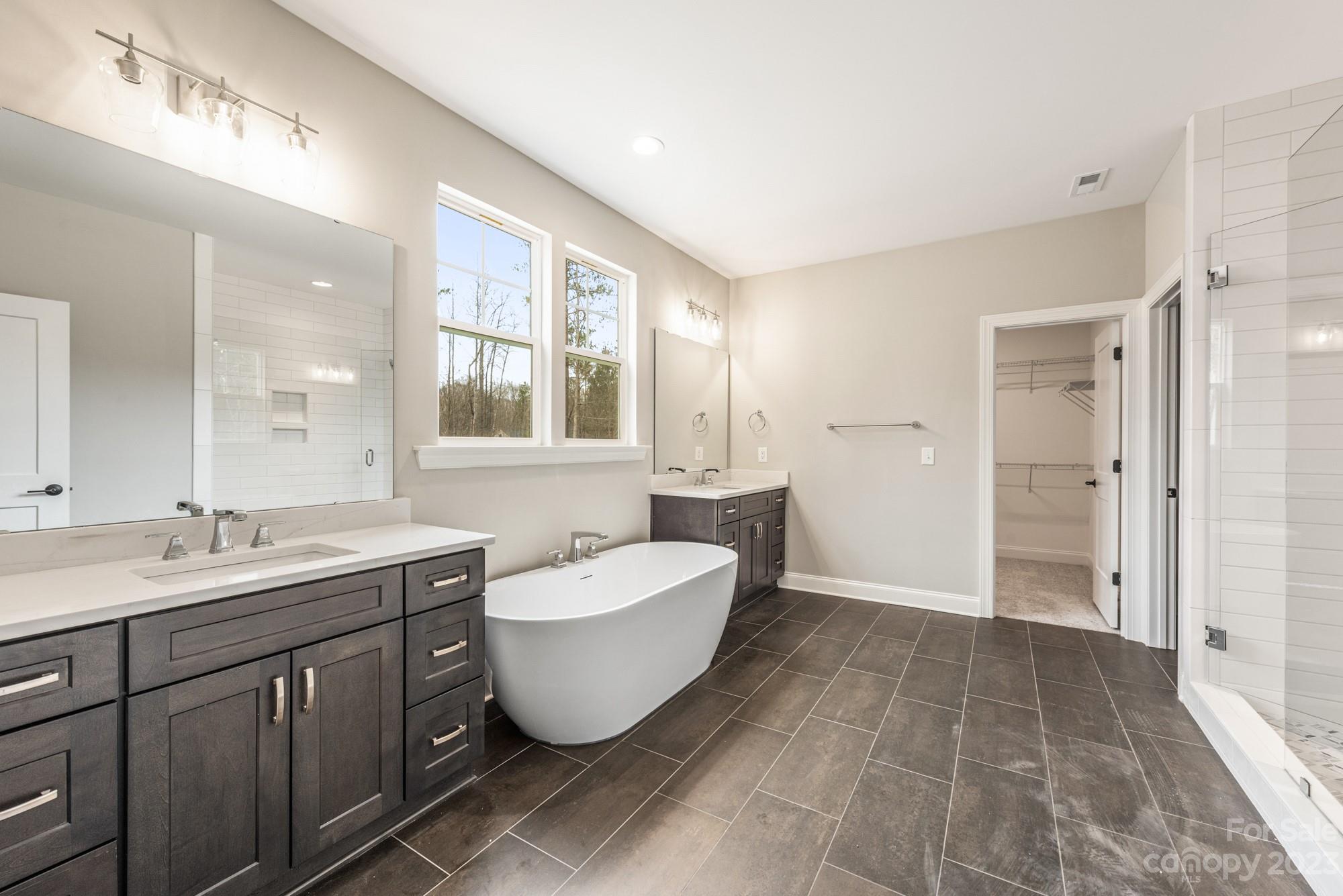4024 Red Hl Way Denver, NC 28037 - Photo 7 of 22 a spacious bathroom with a double vanity sink mirror and a bathtub