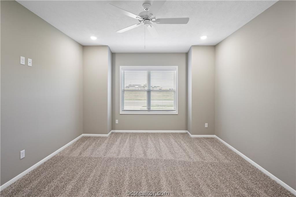 1245 Storm Row Lane Bryan, TX 77803 - Photo 11 of 23 wooden floor in an empty room with a window