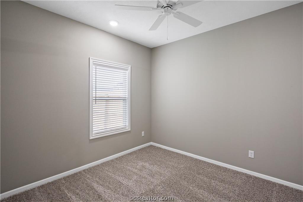 1245 Storm Row Lane Bryan, TX 77803 - Photo 15 of 23 an empty room with a window and a fan
