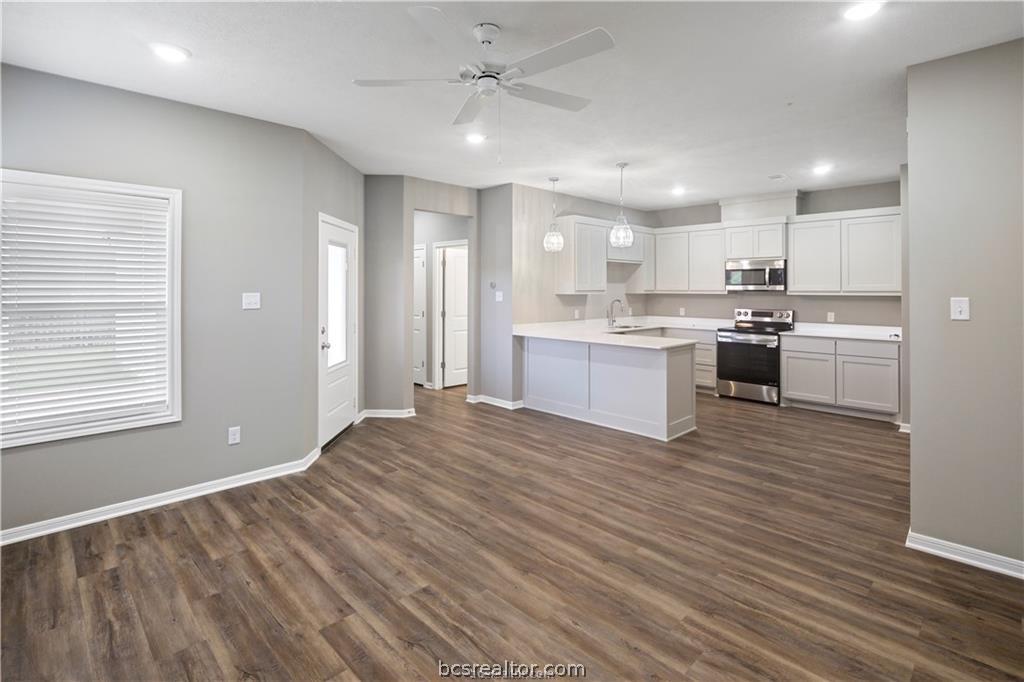 1245 Storm Row Lane Bryan, TX 77803 - Photo 4 of 23 a large kitchen with kitchen island a sink stainless steel appliances and cabinets