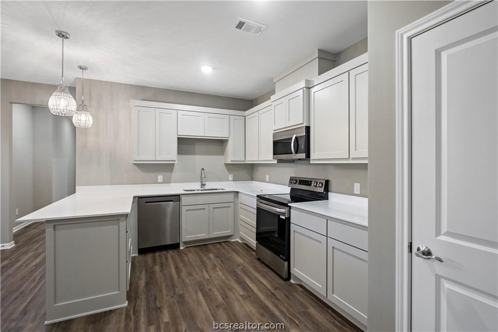 1245 Storm Row Lane Bryan, TX 77803 - Photo 7 of 23 a kitchen with granite countertop appliances cabinets and a sink