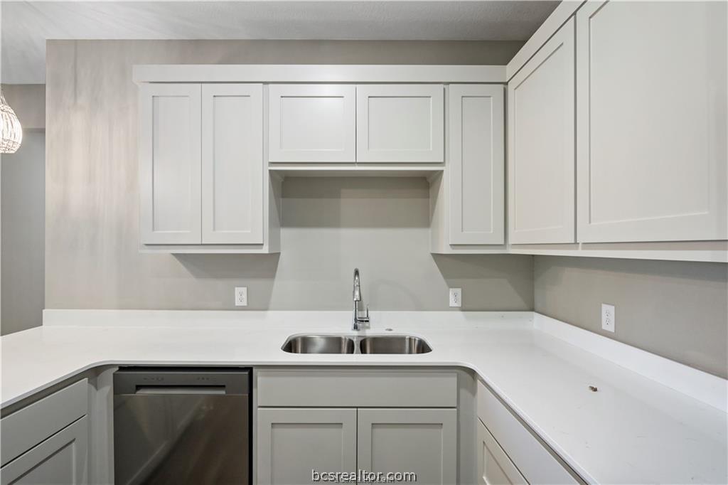 1245 Storm Row Lane Bryan, TX 77803 - Photo 9 of 23 a kitchen with a sink cabinets and stainless steel appliances