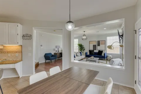 a view of a livingroom with furniture and a view of kitchen
