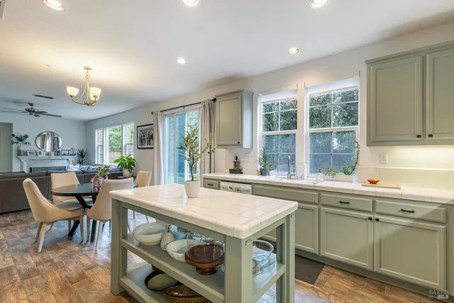 a kitchen with a stove a sink a dining table and chairs