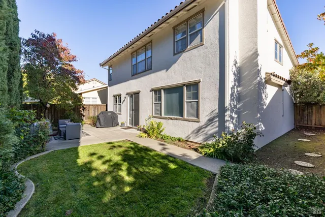 a view of a house with backyard and sitting area