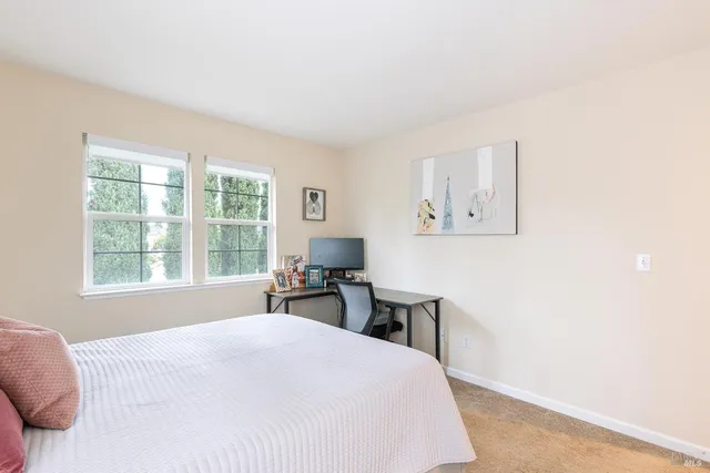 a bedroom with a bed and a table with window