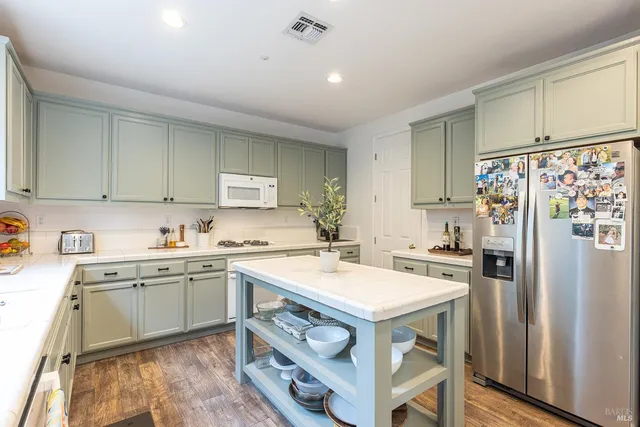 a kitchen with a stove a refrigerator and a sink