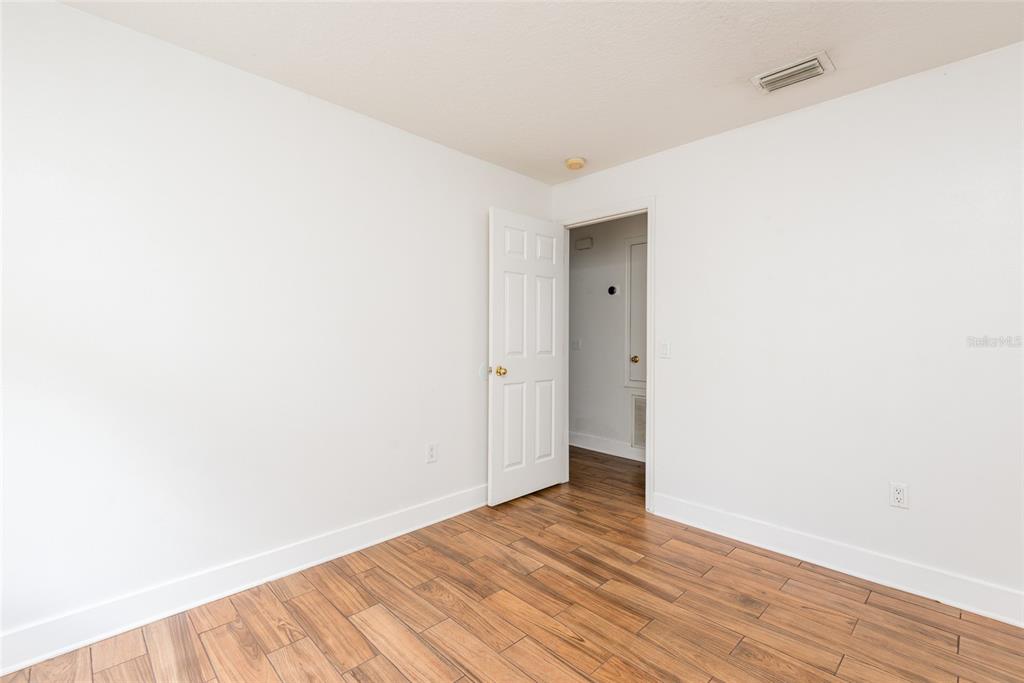 11813 Prickly Pear Way Seffner, FL 33584 - Photo 17 of 21 a view of an empty room with wooden floor