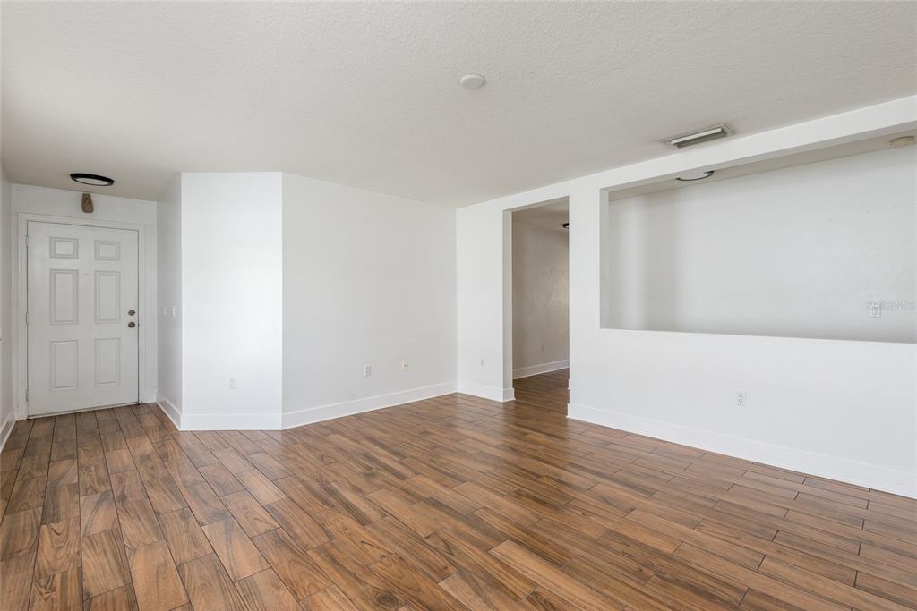11813 Prickly Pear Way Seffner, FL 33584 - Photo 3 of 21 a view of an empty room with wooden floor