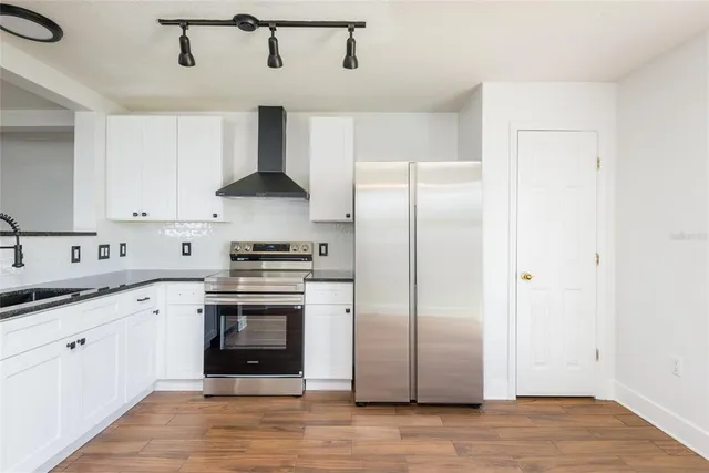 a kitchen with stainless steel appliances granite countertop a stove and a refrigerator