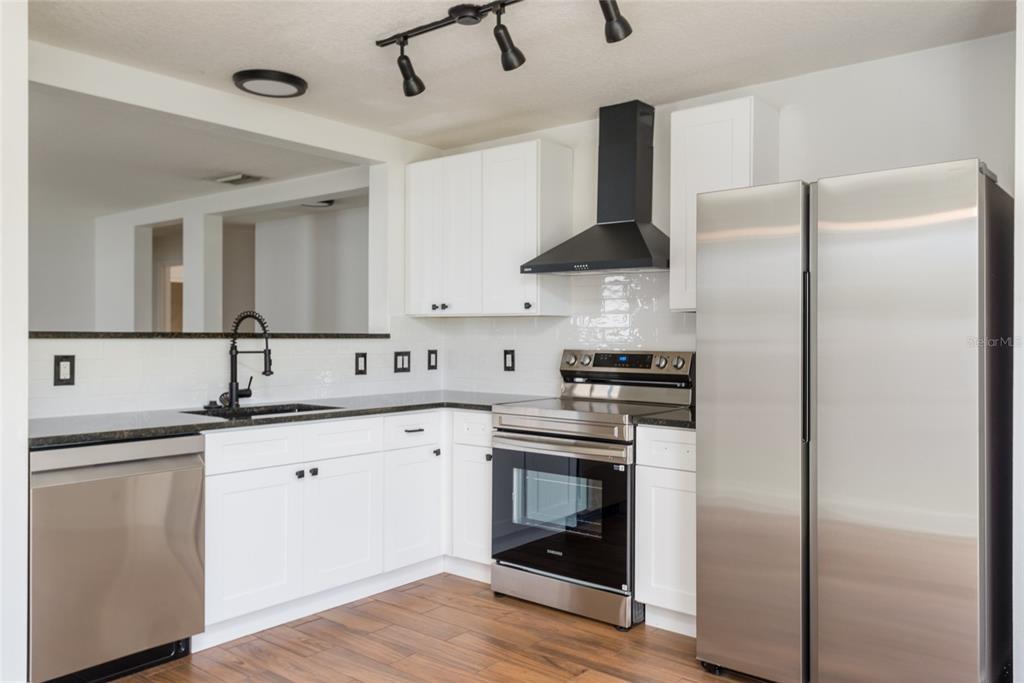 11813 Prickly Pear Way Seffner, FL 33584 - Photo 7 of 21 a kitchen with stainless steel appliances a sink and cabinets