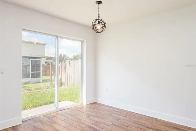 a view of a room with wooden floor and windows