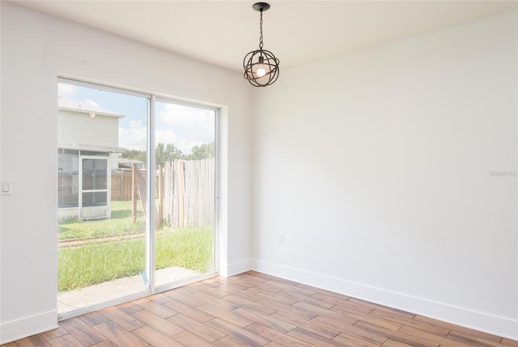 11813 Prickly Pear Way Seffner, FL 33584 - Photo 8 of 21 a view of a room with wooden floor and windows