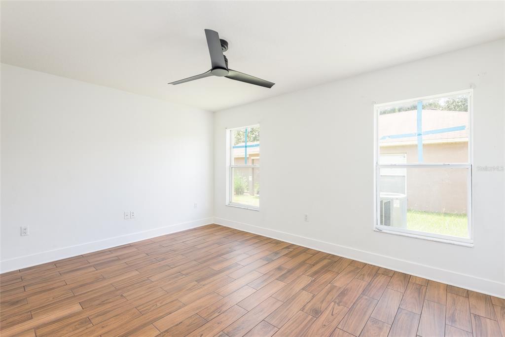 11813 Prickly Pear Way Seffner, FL 33584 - Photo 9 of 21 wooden floor in an empty room with a window