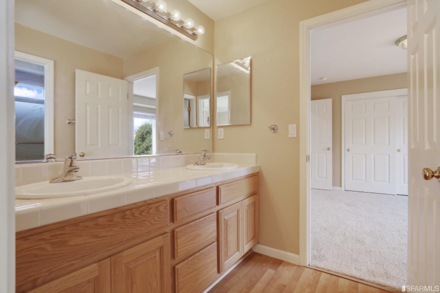 3444 Keystone Loop Discovery Bay, CA 94505 - Photo 24 of 40 a bathroom with a double vanity sink and a mirror