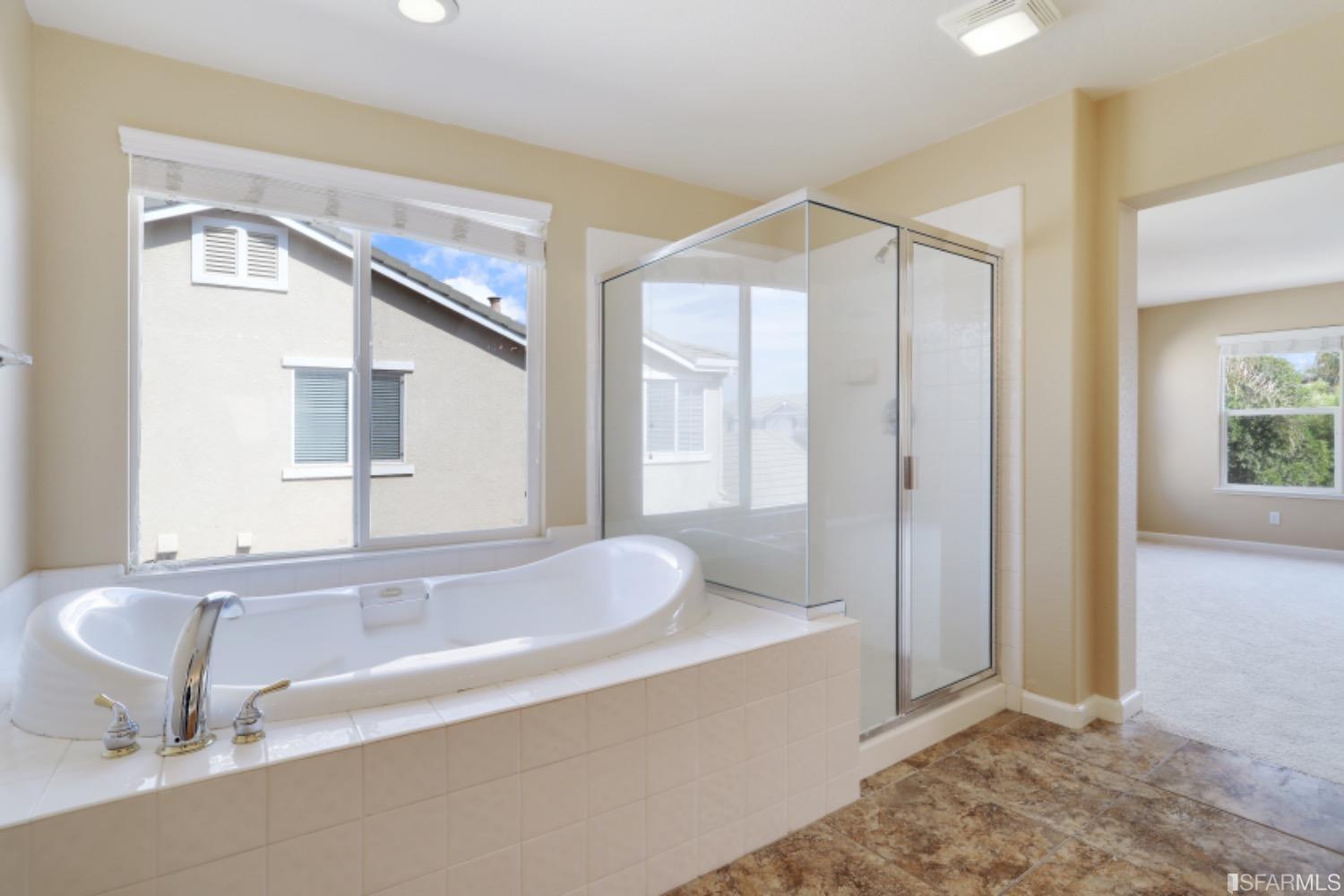 3444 Keystone Loop Discovery Bay, CA 94505 - Photo 30 of 40 a bathroom with a tub sink and mirror