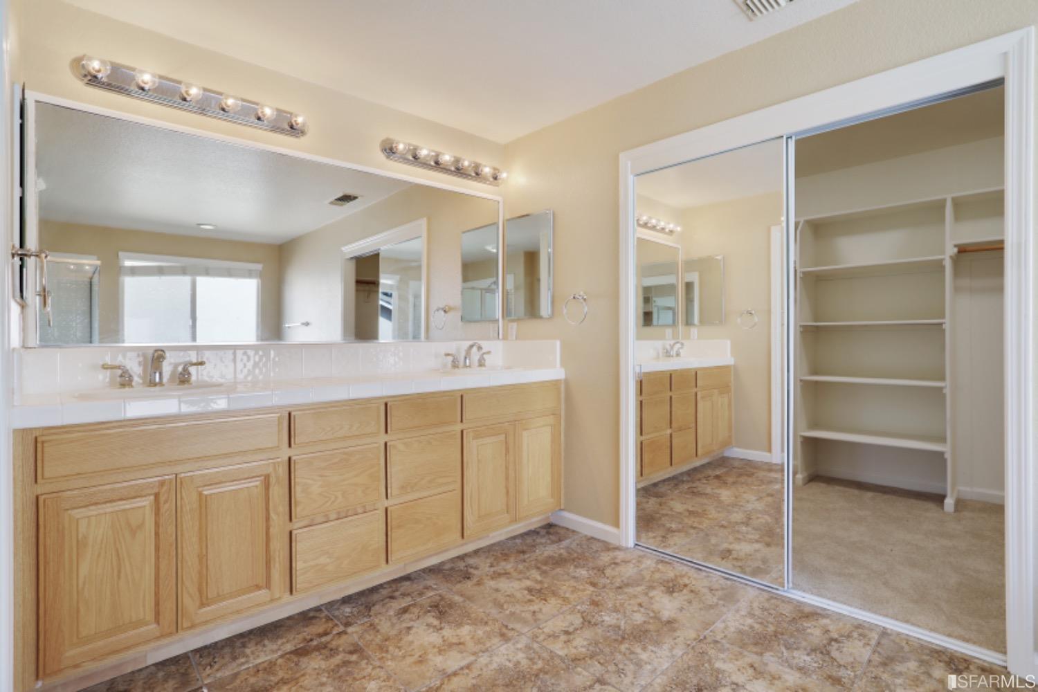 3444 Keystone Loop Discovery Bay, CA 94505 - Photo 31 of 40 a spacious bathroom with a shower sink and mirror